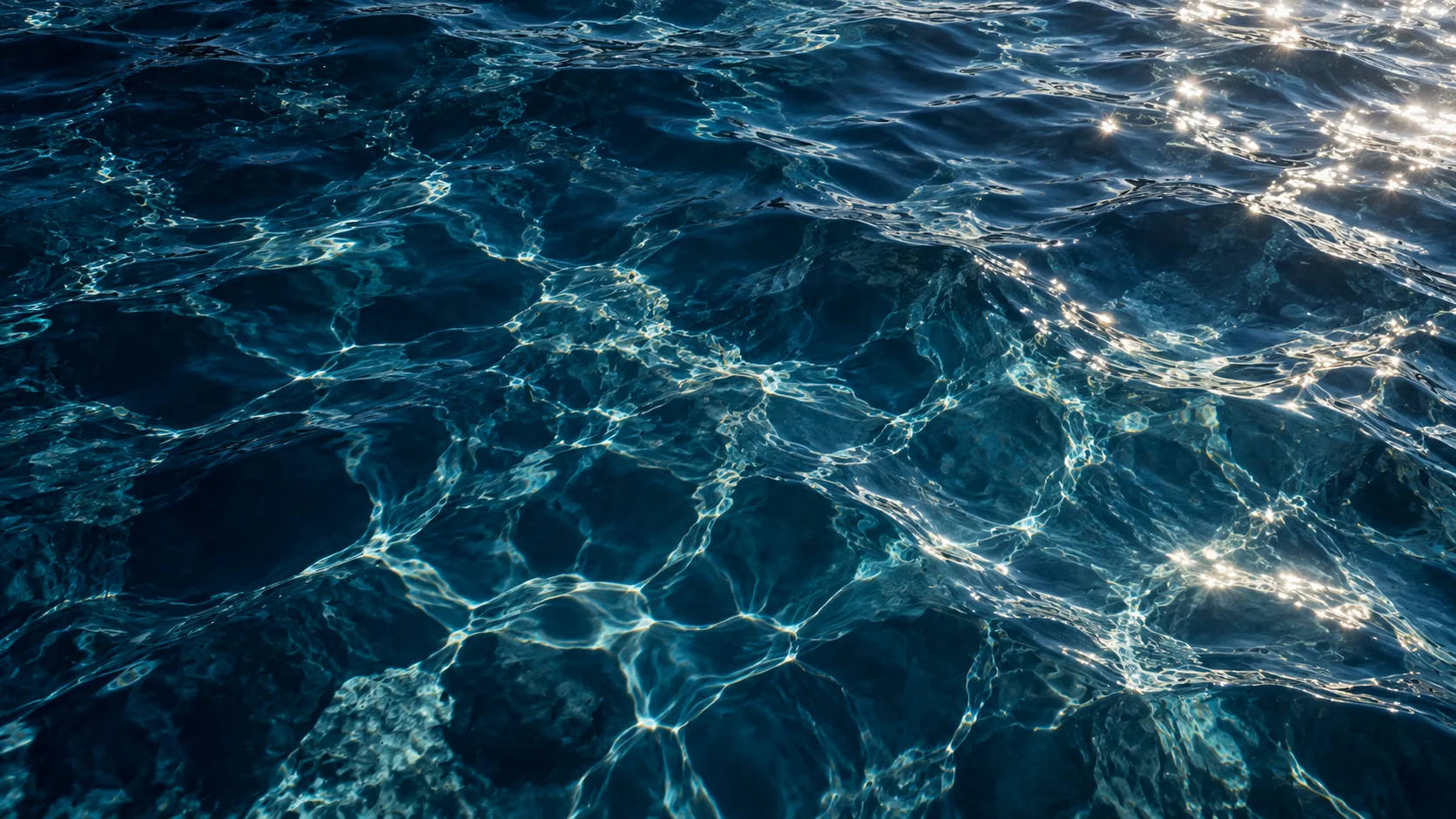 Light rippling through deep blue water